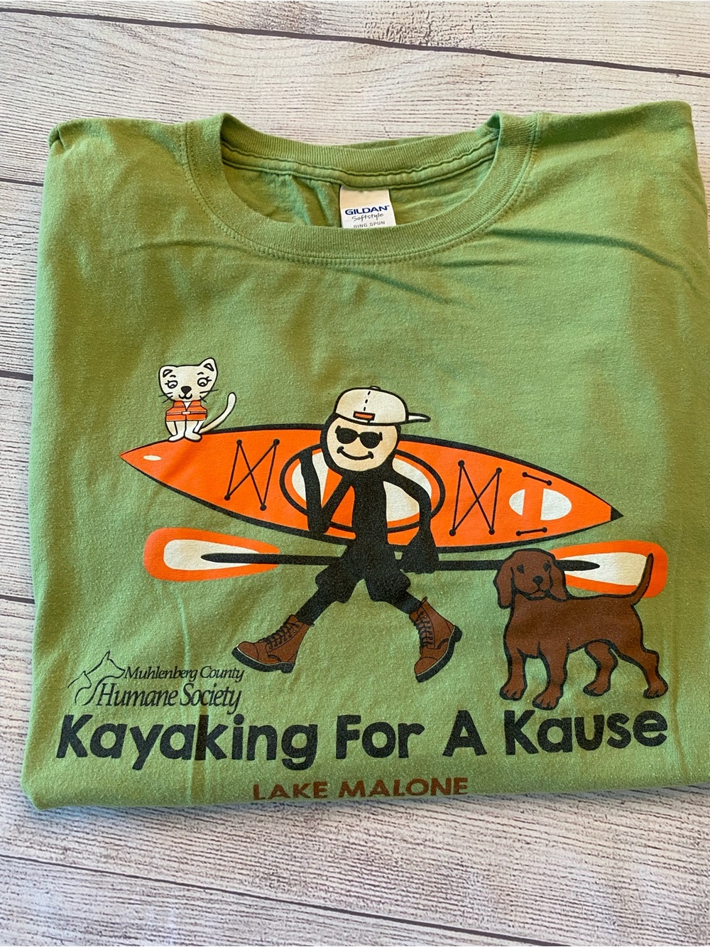 Green Graphic Tee with Orange Kayak, White Cat, and Brown Dog